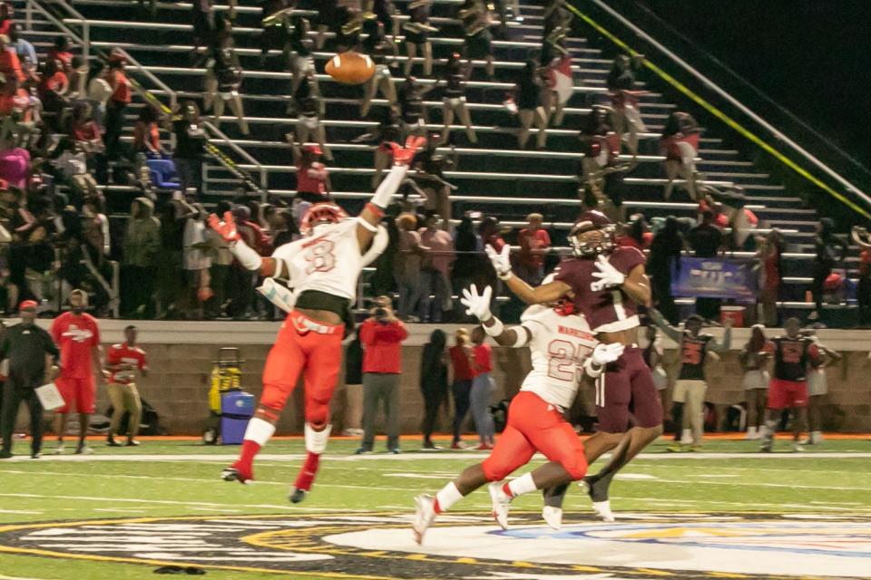 Two Jenkins High defenders go up to block the pass attempt, to Benedictine's Za'Quan Bryan (No. 1) in an Aug. 19 game at Memorial Stadium.