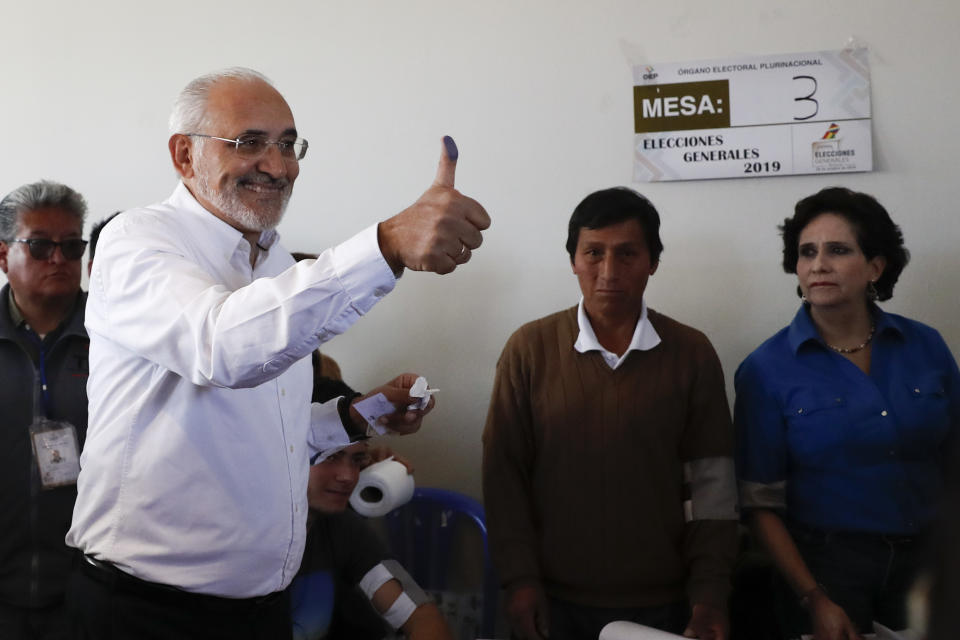 Opposition presidential candidate Carlos Mesa gives a thumbs up after voting during general elections in Mallasilla, in the outskirts of La Paz, Bolivia, Sunday, Oct. 20, 2019. Former president Mesa is the closest rival to President Evo Morales, who is seeking a fourth term in the country's general elections. (AP Photo/Jorge Saenz)