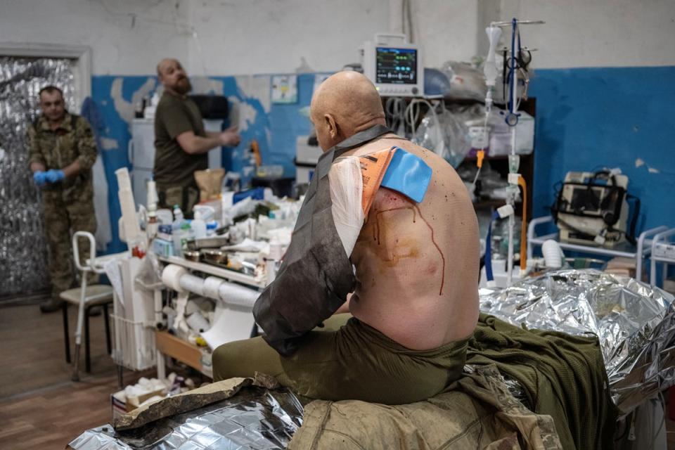 A wounded soldier sits on the operation table (Reuters)