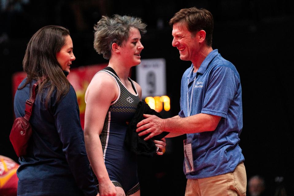 Poudre School District girls wrestler Abbigail Smith jokes with PSD coaches after losing her third place match during the Colorado state wrestling tournament at Ball Arena on Saturday, Feb. 18, 2023 in Denver, Colo.