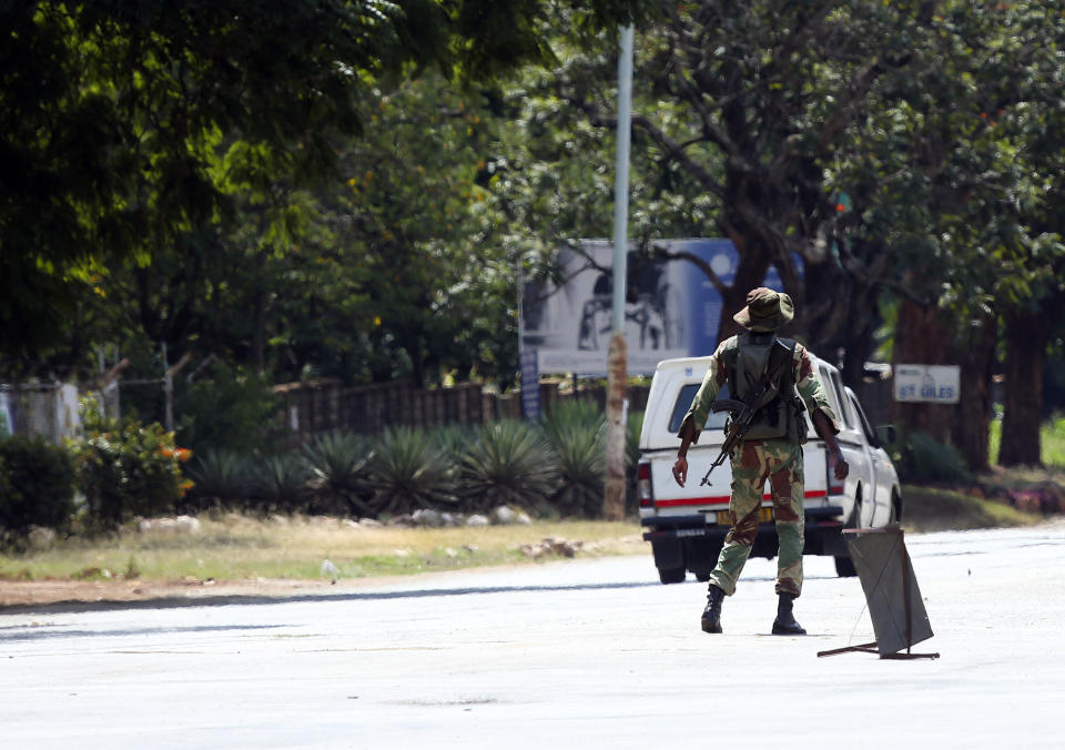 An armed soldier turns away a vehicle during lockdown in Harare, Zimbabwe Monday, April 13, 2020. Zimbabwe is under lockdown in an effort to curb the spread of the coronavirus. The new coronavirus causes mild or moderate symptoms for most people, but for some, especially older adults and people with existing health problems, it can cause more severe illness or death. (AP Photo/Tsvangirayi Mukwazhi)
