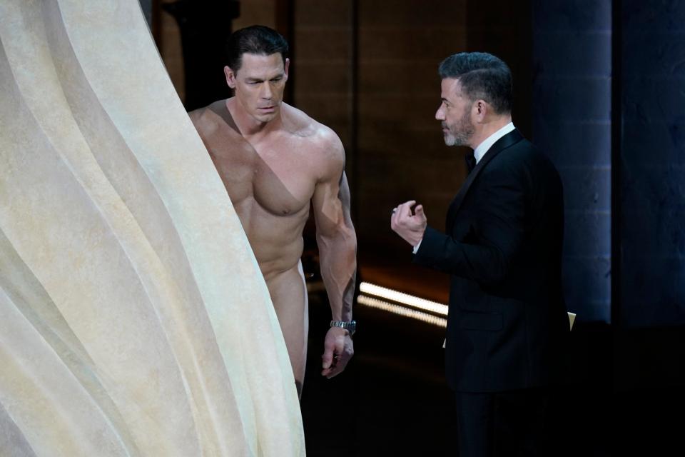 John Cena, left, presents the award for achievement in costume design along with Jimmy Kimmel during the 96th Oscars at the Dolby Theatre at Ovation Hollywood in Los Angeles on March 10, 2024.