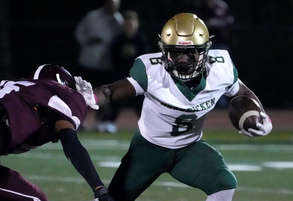 Hendricken running back Oscar Weah keeps his distance from La Salle defender Antoniio Bearden running around end in the first half.