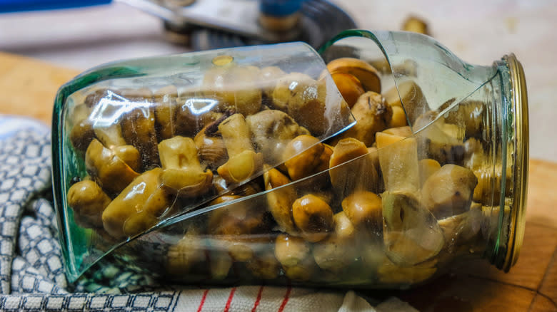 Broken mason jar with mushrooms 
