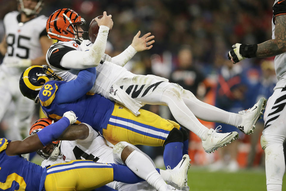 Cincinnati Bengals quarterback Andy Dalton, top, is sacked by Los Angeles Rams defensive tackle Aaron Donald during the second half of an NFL football game, Sunday, Oct. 27, 2019, at Wembley Stadium in London. (AP Photo/Tim Ireland)