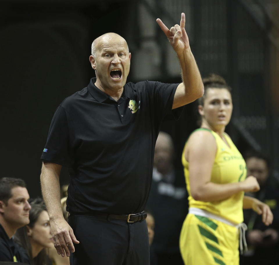 Oregon coach Kelly Graves, left, calls to his team with player Erin Boley, right, nearby during the first half of an NCAA college basketball game against Arizona State on Friday, Jan. 18, 2019. in Eugene, Ore. (AP Photo/Chris Pietsch)