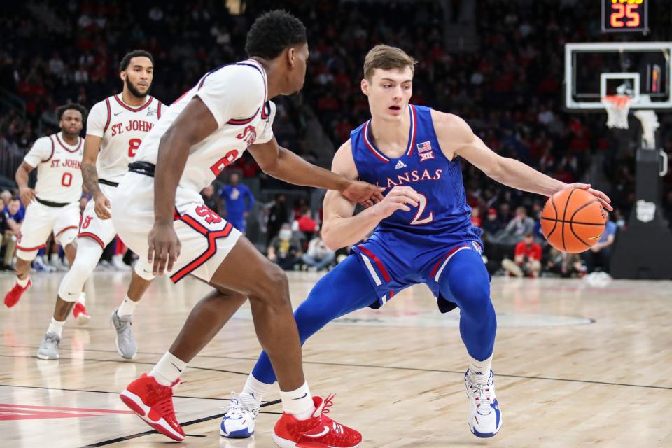 Dec 3, 2021; Elmont, New York, USA;  Kansas Jayhawks guard Christian Braun (2) tries to drives past St. John’s Red Storm guard Montez Mathis (23) in the first half at UBS Arena. Mandatory Credit: Wendell Cruz-USA TODAY Sports