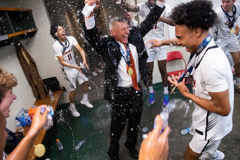 Central York head coach Jeff Hoke is greeted with a water bath in the locker room after winning the PIAA Class 6A Boys Basketball Championship against Parkland at the Giant Center on March 23, 2024, in Hershey. The Panthers won, 53-51.