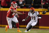 Kansas City Chiefs tight end Travis Kelce (87) tosses the ball as Cincinnati Bengals cornerback Mike Hilton (21) looks on during the first half of the NFL AFC Championship playoff football game, Sunday, Jan. 29, 2023, in Kansas City, Mo. (AP Photo/Jeff Roberson)