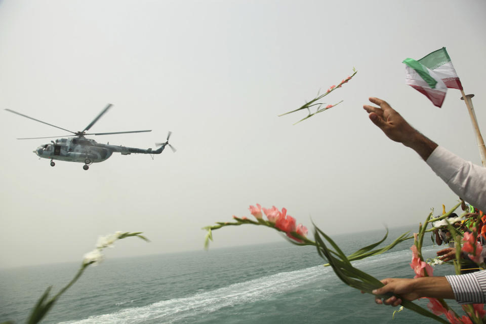 FILE - In this July 3, 2011 file photo, Iranians scatter flowers into the Persian Gulf at the site where an Iranian passenger plane was downed by a U.S. warship, killing all 290 aboard. The Western allegation that Iran shot down a Ukrainian jetliner and killed 176 people offers a grim echo for the Islamic Republic, which found itself the victim of an accidental shootdown by American forces over 30 years ago. (AP Photo/Fars News Agency, Majid Jamshidi, File)