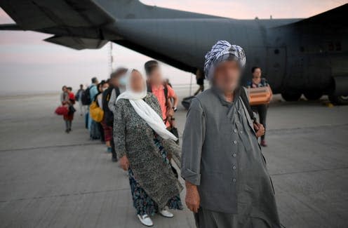 <span class="caption">Evacuees from Kabul on their way to Poland via Uzbekistan. </span> <span class="attribution"><a class="link " href="https://webgate.epa.eu/?16634349628007773501&MEDIANUMBER=57124954" rel="nofollow noopener" target="_blank" data-ylk="slk:Marcin Obara / EPA-EFE;elm:context_link;itc:0;sec:content-canvas">Marcin Obara / EPA-EFE</a></span>