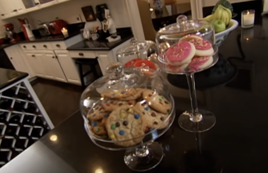 Glass jars on a kitchen counter filled with an assortment of cookies