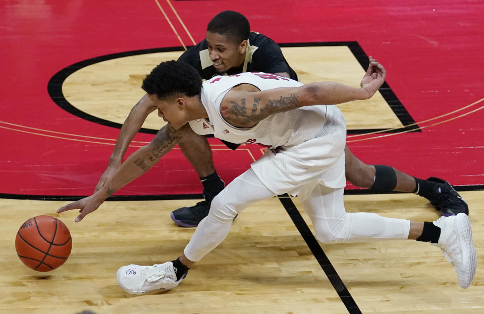 Rutgers guard Jacob Young, front, and Purdue guard Isaiah Thompson, rear, go after a loose ball during the second half of an NCAA college basketball game Tuesday, Dec. 29, 2020, in Piscataway, N.J. (AP Photo/Kathy Willens)
