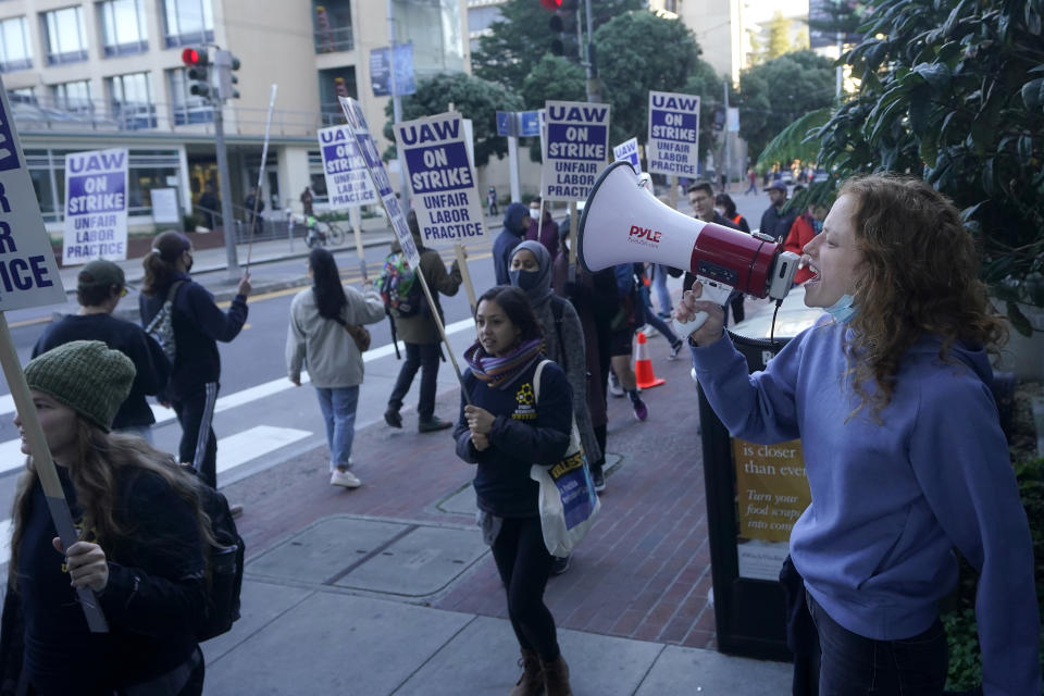 Madison Moss, associate researcher at the University of California San Francisco, right, takes part in a protest outside of UCSF medical offices in San Francisco, Monday, Nov. 14, 2022. Nearly 48,000 unionized academic workers at all 10 University of California campuses have walked off the job Monday. (AP Photo/Jeff Chiu)