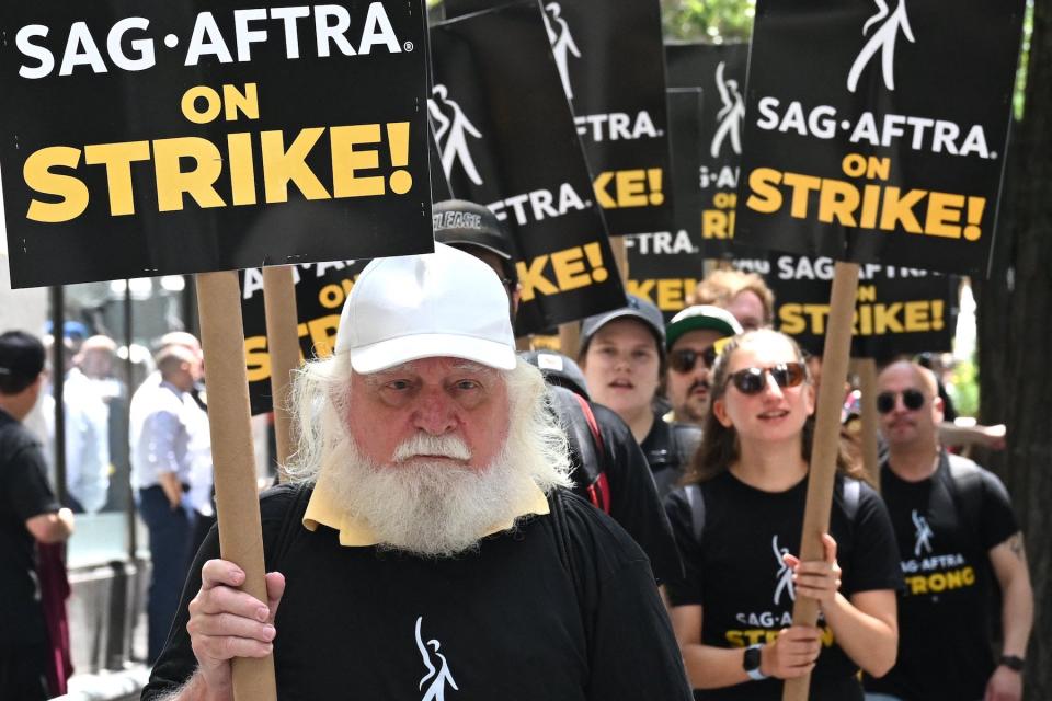 Members of the Writers Guild of America and the Screen Actors Guild walk a picket line outside NBC Universal in New York City on July 14, 2023.