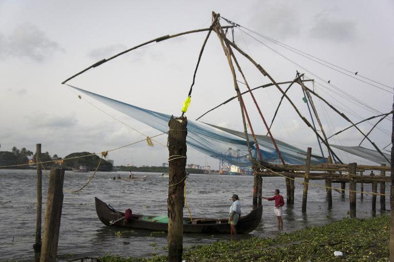 Chinese fishing nets hang over the water in Kochi, Kerala, September 12, 2014. But the Indian town now depends on tourists not fish