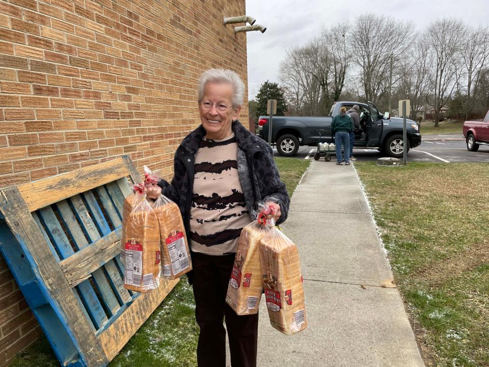 Food Pantry Coordinator Suzanne Hawley secures the bread at Center Faith Church Friday, Jan. 21, 2022.