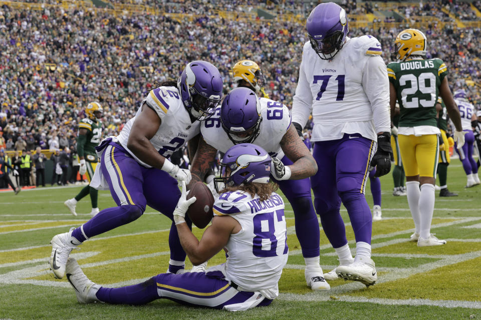 Minnesota Vikings tight end T.J. Hockenson (87) celebrates with teammates after catching a 2-yard touchdown pass during the second half of an NFL football game against the Green Bay Packers, Sunday, Oct. 29, 2023, in Green Bay, Wis. (AP Photo/Mike Roemer)