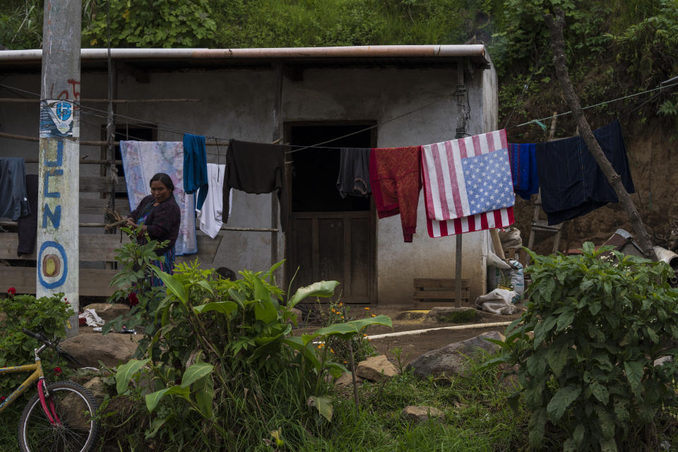 A Mam Indigenous woman carries firewood at her home in San Martin Sacatepequez, Guatemala, Tuesday, June 8, 2021. The Mam Indigenous community is an agricultural place transformed with the remittances that migrants send to their families. (AP Photo/Moises Castillo)