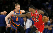 New York Knicks guard Donte DiVincenzo (0) defends Chicago Bulls forward Torrey Craig (13) during the first half of an NBA basketball game Sunday, April 14, 2024, in New York. (AP Photo/John Munson)