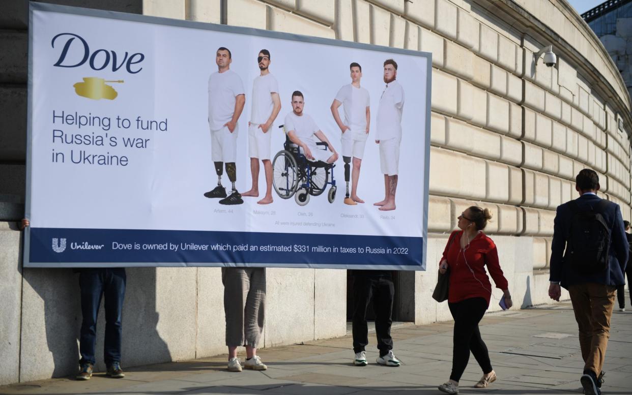 A giant billboard showing a photoshoot with wounded Ukrainian soldiers, in the style of Dove beauty adverts, has been installed outside parent company Unilever's HQ in London
