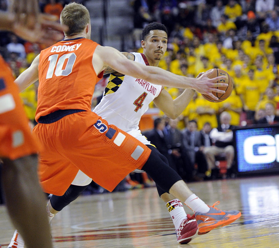 Maryland guard Seth Allen (4) looks to pass against Syracuse guard Trevor Cooney (10) during the second half of an NCAA college basketball game, Monday, Feb. 24, 2014, in College Park, Md. Syracuse won 57-55. (AP Photo/Nick Wass)