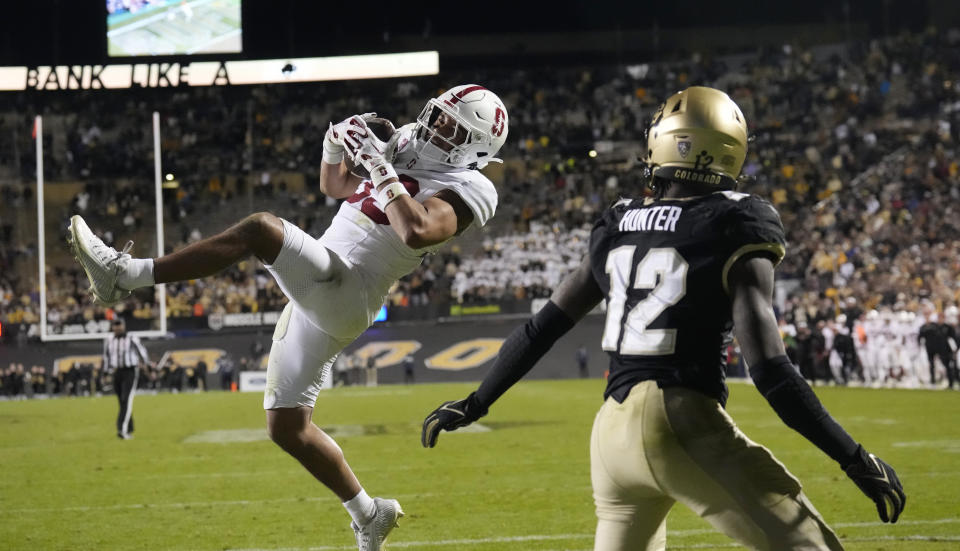 Stanford safety Alaka'i Gilman, left, intercepts a pass intended for Colorado wide receiver Travis Hunter in the end zone in overtime of an NCAA college football game early Saturday, Oct. 14, 2023, in Boulder, Colo. (AP Photo/David Zalubowski)