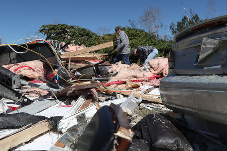 People look for belongings from their destroyed trailer home after two deadly back-to-back tornadoes, in Beauregard, Alabama, U.S., March 5, 2019. REUTERS/Shannon Stapleton