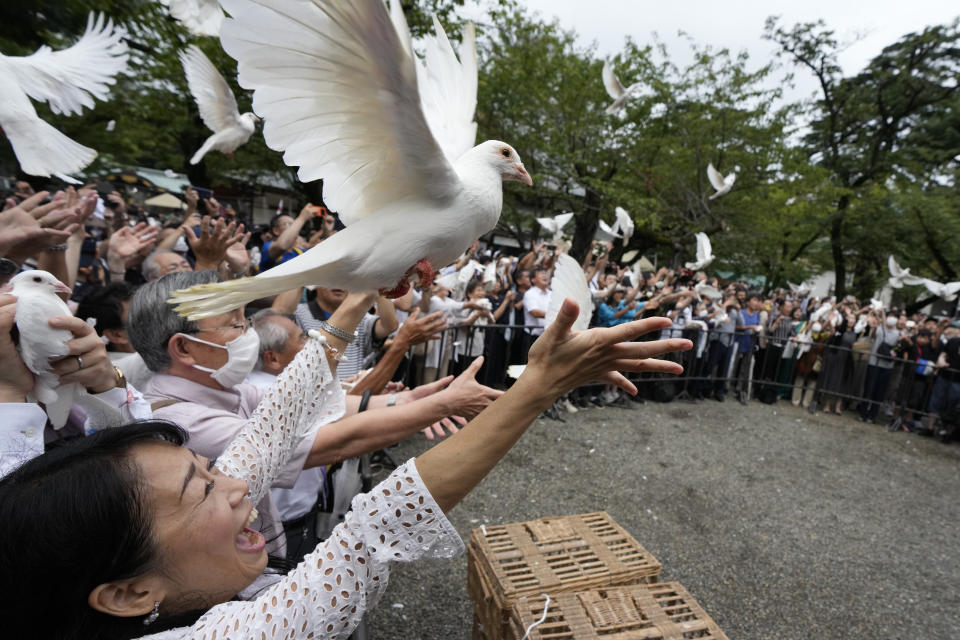 Doves are released in prayer of peace by worshippers at the Yasukuni Shrine in Tokyo, Japan, Tuesday, Aug. 15, 2023. Japan held the annual memorial service for the war dead as the country marks the 78th anniversary of its defeat in the World War II. (AP Photo/Eugene Hoshiko)
