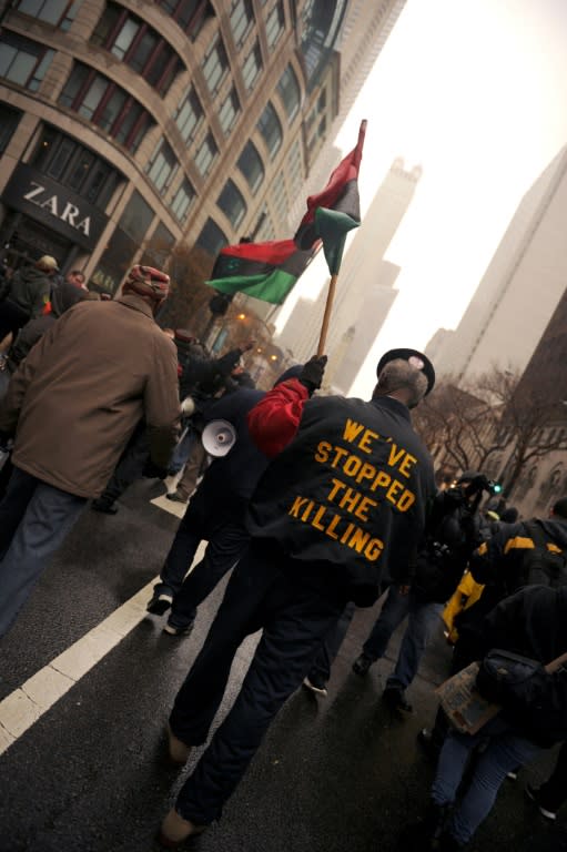 Protesters march on Chicago's Magnificent Mile shopping strip during the Black Friday shopping day on November 27, 2015