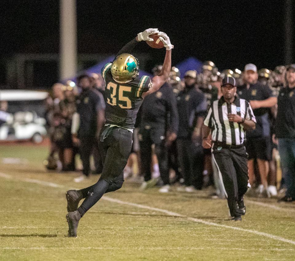 Trinity Catholic Celtic's tight end Mekai Griffin (35) with the pass completion from Trinity Catholic Celtic's quarterback Preston Wright (10) against John Carroll in the first half at Trinity Catholic in Ocala, FL on Friday, December 2, 2022. [Cyndi Chambers/Ocala Star Banner] 2022