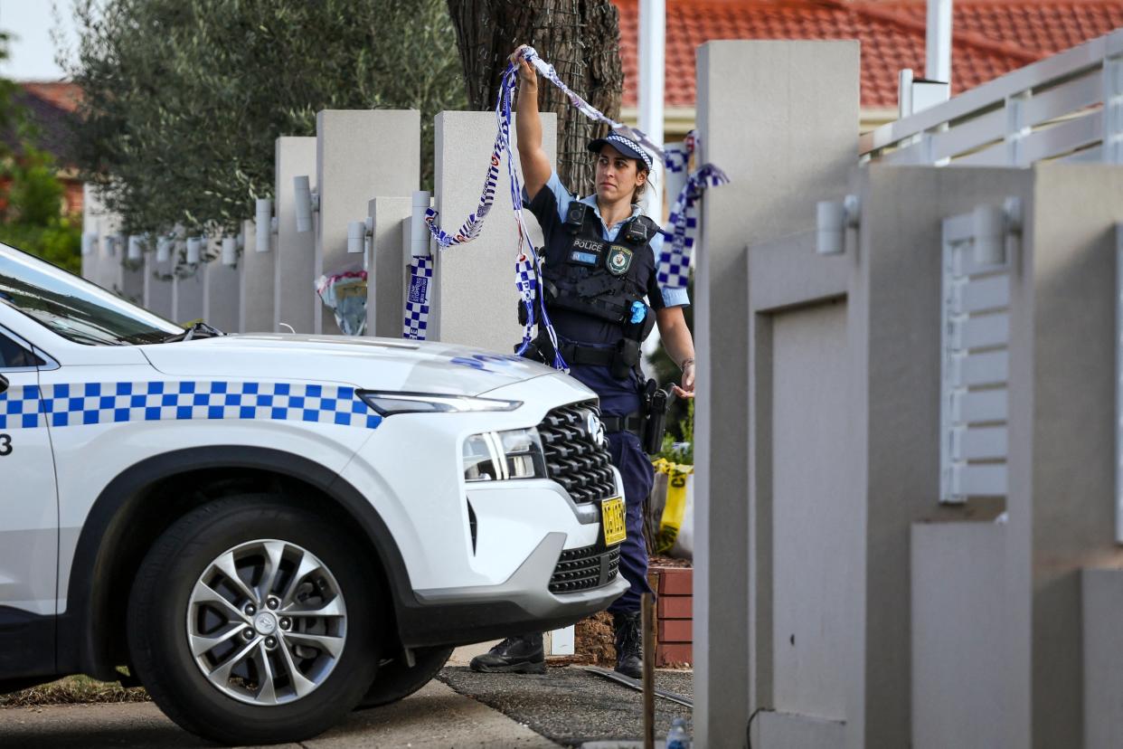 A police officer lifts tape to let a car into the Christ the Good Shepherd Church in Sydney’s western suburb of Wakeley on 16 April 2024 (AFP via Getty Images)