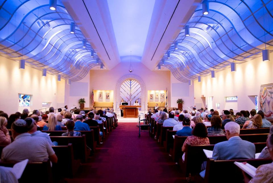 Rabbis Carlie Daniels and Ryan Daniels the co-senior rabbis of the congregation lead Shabbat services at Temple Israel August 18, 2023 in West Palm Beach.