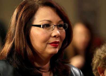 FILE PHOTO: Senator Tammy Duckworth (D-IL) participates in a mock swearing-in with U.S. Vice President Joe Biden during the opening day of the 115th Congress on Capitol Hill in Washington, U.S., January 3, 2017. REUTERS/Joshua Roberts/File Photo