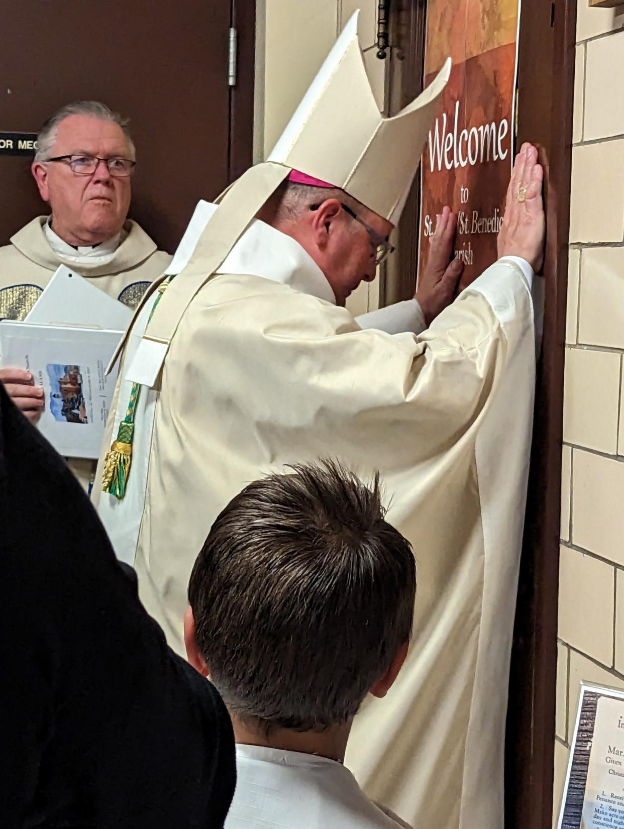 Bishop David Bonnar offers a final blessing Monday, Nov. 6, 2023, at St. Mary of the Immaculate Catholic Church in Canton. The 123-year-old church celebrated a final Mass on Monday. Looking on is the Rev. Kevin Peters, pastor of the newly formed St. Francis of Assisi parish.