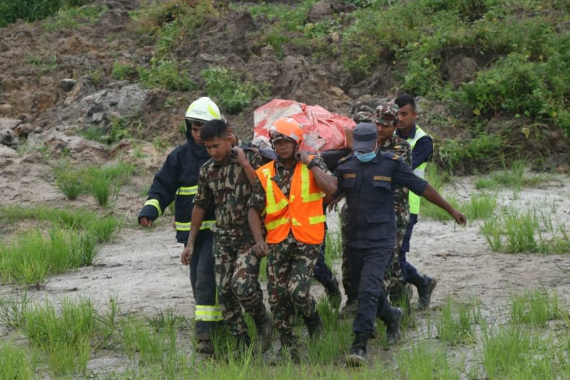 Rescue teams work after a Saurya Airlines plane crashed at Tribhuvan International Airport in Kathmandu.  At least 18 people have been confirmed dead after a plane crash in Nepal on Wednesday, police said.  Aryan Dhimal/ZUMA Press Wire/dpa