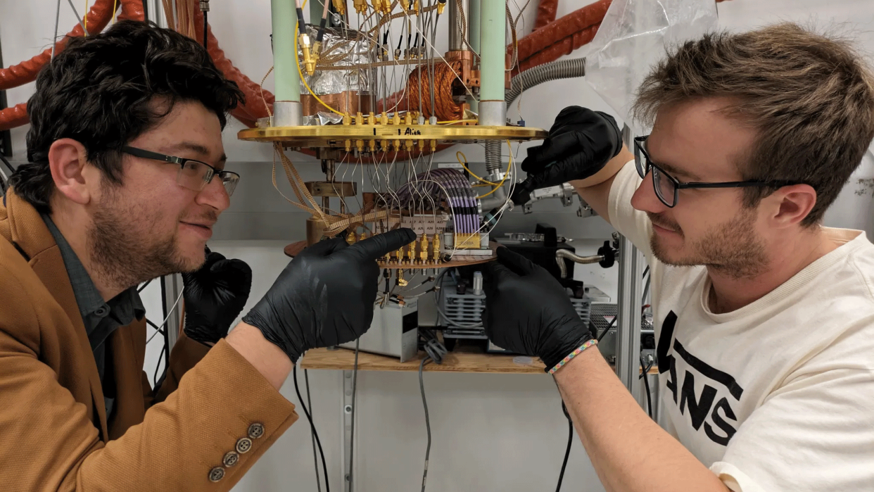  NIST team members Bakhrom Oripov (left) and Ryan Morgenstern (right) mount the superconducting camera to a specialized cryogenic stage Credit: Adam McCaughan/NIST. 