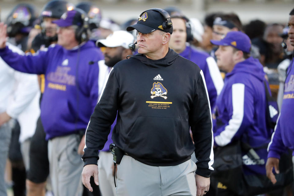 FILE - East Carolina head coach Mike Houston watches from the sideline during the first half of an NCAA college football game against Cincinnati in Greenville, N.C., Friday, Nov. 26, 2021. East Carolina will host No. 13 North Carolina State on Saturday to open the season. (AP Photo/Karl B DeBlaker, File)