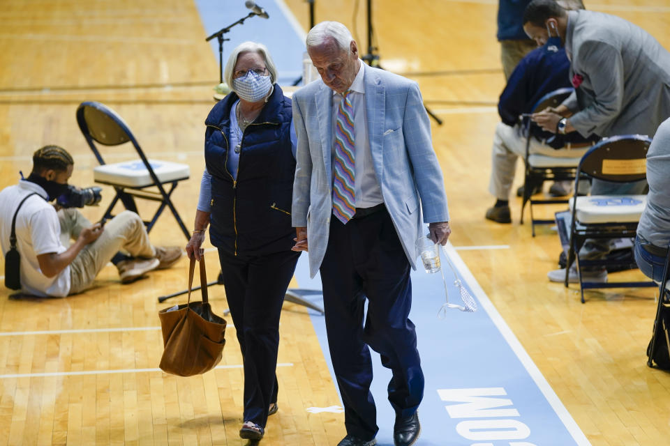 North Carolina Head Basketball Coach Roy Williams and his wife Wanda leave the court after news conference, Thursday, April 1, 2021, in Chapel Hill, N.C. Williams is retiring after 33 seasons and 903 wins as a college basketball head coach. The Hall of Fame coach led the University of North Carolina to three NCAA championships in 18 seasons as head coach of the Tar Heels. (AP Photo/Gerry Broome)