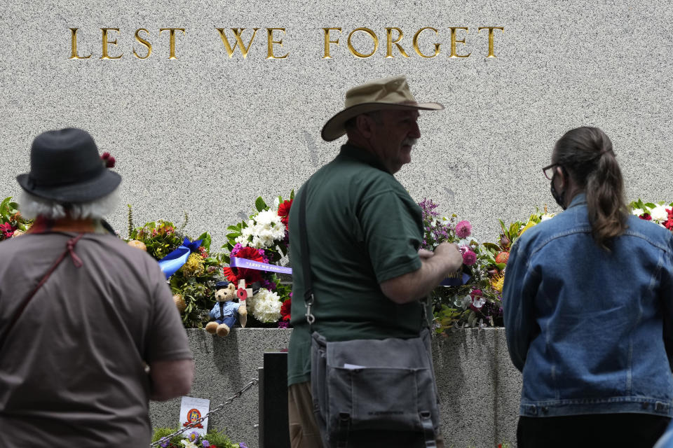 People look at a wreaths and other tributes at the cenotaph following Remembrance Day ceremonies in Sydney, Friday, Nov. 11, 2022. (AP Photo/Rick Rycroft)