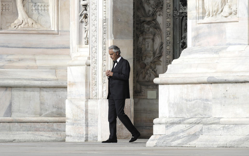 FILE - In this Sunday, April 12, 2020, Italian singer Andrea Bocelli performs outside the Duomo cathedral, in Milan, Italy. Italian tenor Andrea Bocelli, who had COVID-19, says the pandemic lockdown in his country made him feel “humiliated and offended” for depriving him of freedom. Bocelli spoke at a panel held on Monday in a Senate conference room, where he was introduced by right-wing opposition leader Matteo Salvini, who has railed against the government's stringent measures aimed at reining in the coronavirus outbreak. (AP Photo/Luca Bruno, File)