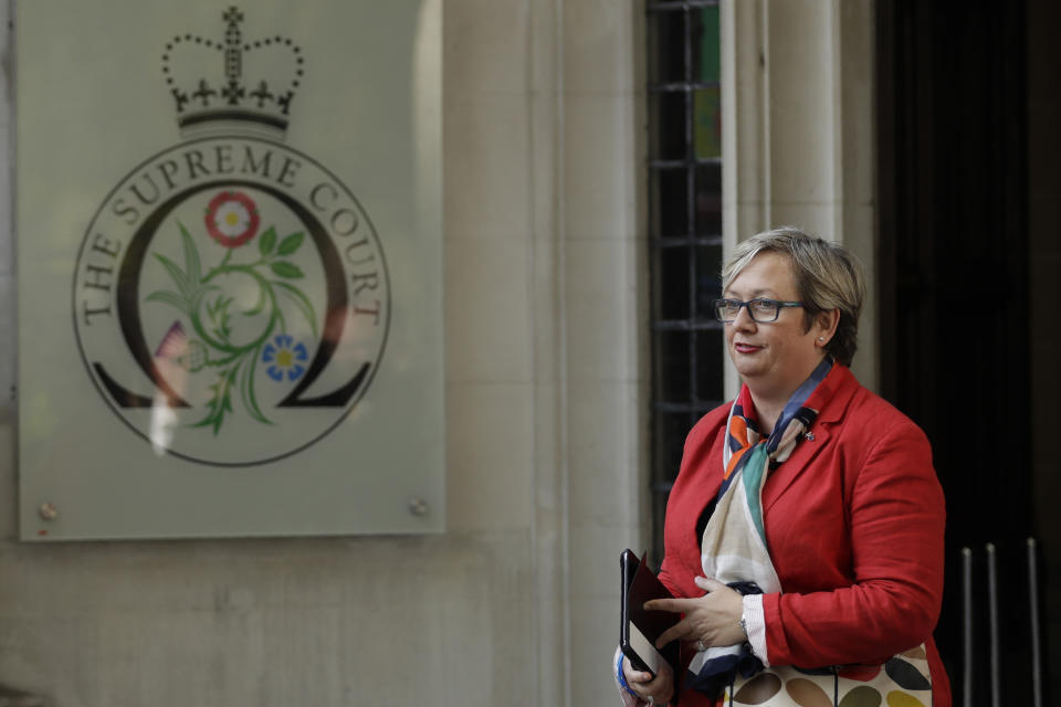 Joanna Cherry, the Scottish National Party's Justice and Home Affairs spokesperson, poses for photographers as she arrives at the Supreme Court in London, Tuesday Sept. 17, 2019. The Supreme Court is set to decide whether Prime Minister Boris Johnson broke the law when he suspended Parliament on Sept. 9, sending lawmakers home until Oct. 14 — just over two weeks before the U.K. is due to leave the European Union. (AP Photo/Matt Dunham)