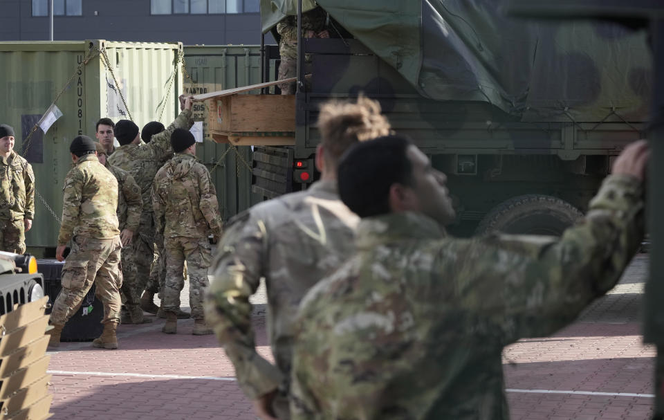 U.S. troops load equipment onto vehicles in Rzeszow, Poland, on Saturday, Feb. 19, 2022. The U.S. has recently sent nearly 5,000 troops to NATO ally Poland, in addition to the 4,000 that are on a perment rotation in Poland. The aim is to reassure a nervous ally amid fears that Russia could attack Ukrain.(AP Photo/Czarek Sokolowski)