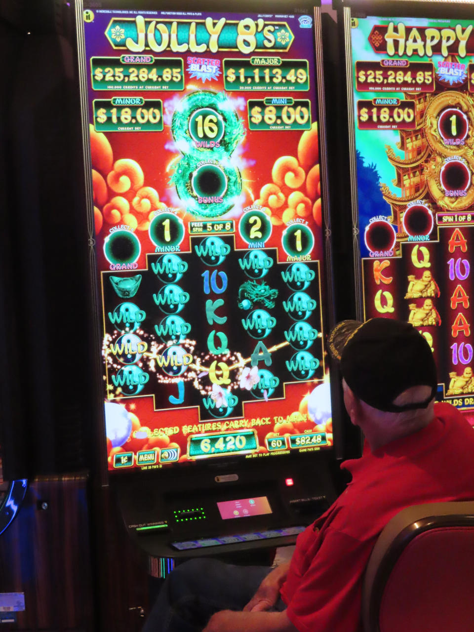 A gambler plays a slot machine at the Hard Rock Casino in Atlantic City, N.J., on Aug. 8, 2022. Figures released on Nov. 9, 2022, by the American Gaming Association show the U.S. commercial casino industry had its best quarter ever, winning over $15 billion from gamblers in the third quarter of this year. (AP Photo/Wayne Parry)