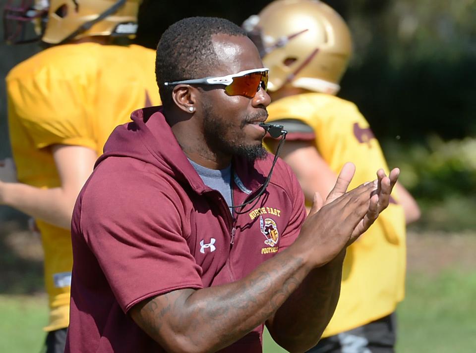 North East High School head football coach Jovon Johnson leads warm-up drills to begin practice in North East on Aug. 23, 2022.