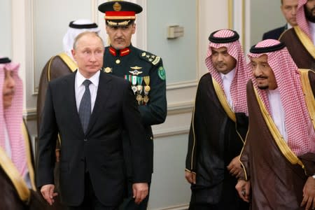 Russian President Vladimir Putin and Saudi Arabia's King Salman attend the official welcome ceremony in Riyadh