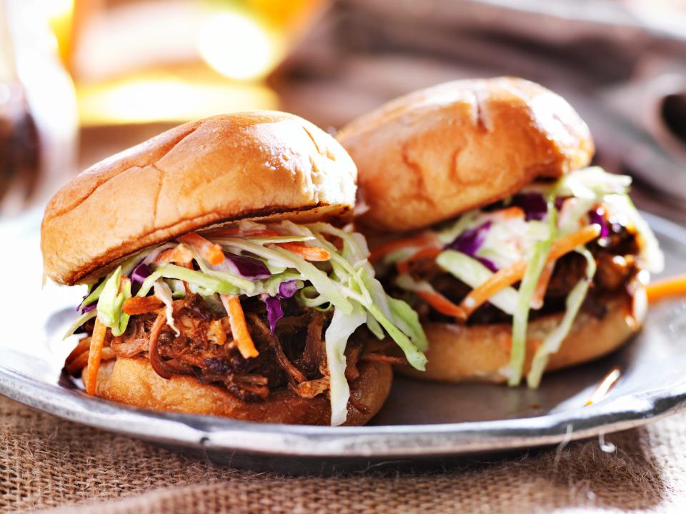 pulled pork sandwiches with coleslaw on a plate