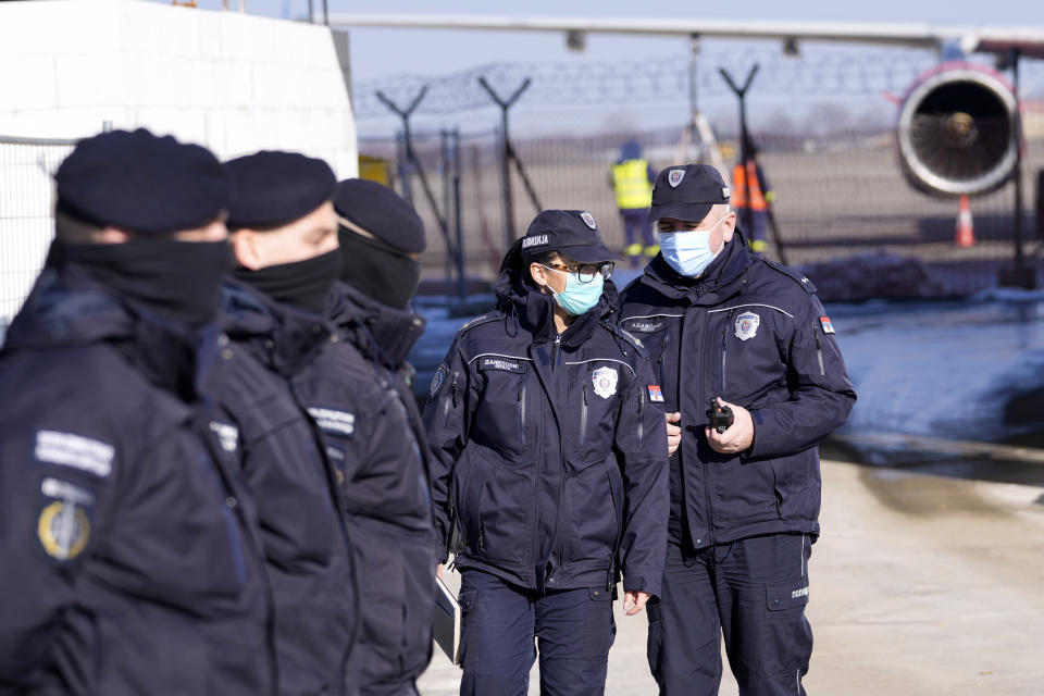 Police forces guard the area waiting for arrival of Novak Djokovic in front of the VIP terminal at the Nikola Tesla airport in Belgrade, Serbia, Monday, Jan. 17, 2022. Djokovic is expected to arrive in the Serbian capital following his deportation from Australia on Sunday after losing a bid to stay in the country to defend his Australian Open title despite not being vaccinated against COVID-19. (AP Photo/Darko Vojinovic)