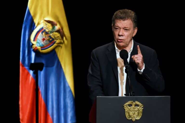 Colombian President Juan Manuel Santos and FARC leader Rodrigo Londono returned Friday to the same Bogota theater where they signed the deal a year ago to end Latin America's longest war