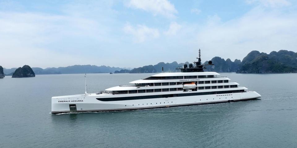 A cruise ship on a body of water on a semi-cloudy day.